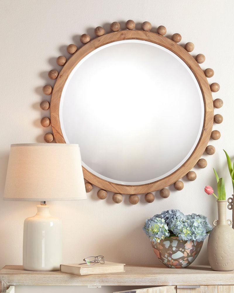 round mirror above a side table