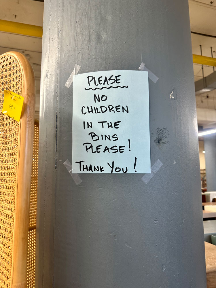 Sign that says don't let children play in the bins