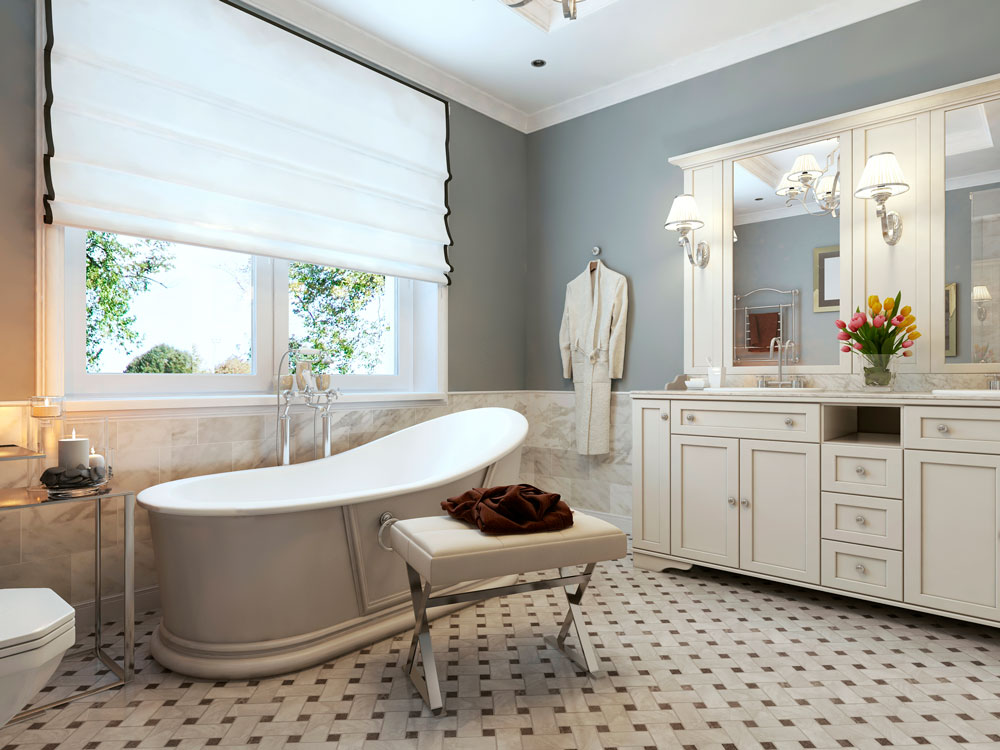 Luxurious bathroom with soaking tub, marble mosaic floor and white cabinets