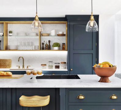 Kitchen with blue cabinets and while and gold accents