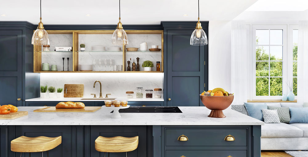 Beautifully designed kitchen with blue cabinets, marble and brass accents